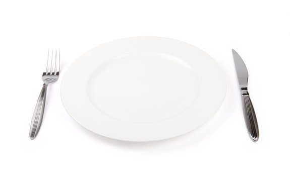porcelain plate with fork and knife isolated on white