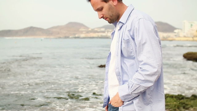 Man standing on the beach, slow motion, steadicam shot