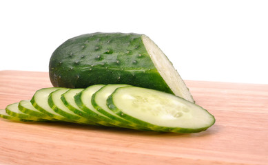 sliced cucumber on the cutting board isolated on the white backg