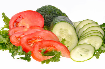 green salad, sliced tomato and cucumber isolated on the white ba
