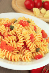 Pasta fusilli with tomatoe sauce, capers and parmesan