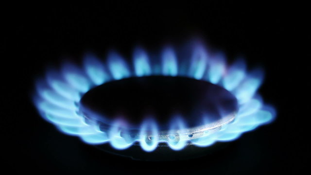 Natural gas inflammation in stove burner, close up view