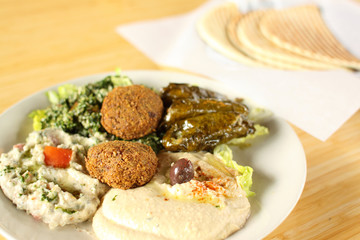 Falafel plate with hummus, baba ganoush, tabouli, and dolmas.