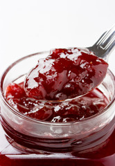Close up of thick sweet strawberry jam preserve on a spoon.