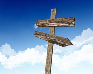 Blank road signs against blue sky
