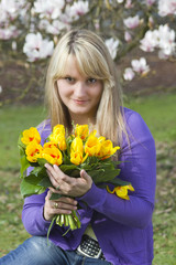 Naklejka premium Happy woman holding flowers