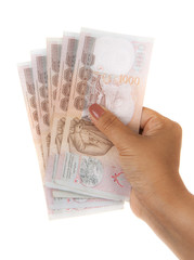 Hand holding thai money on white background.
