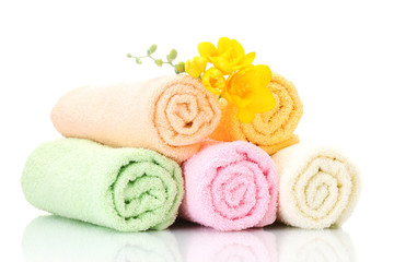 Obraz na płótnie Canvas colorful towels and flowers isolated on white