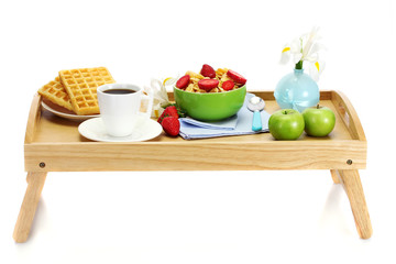 light breakfast on wooden tray isolated on white