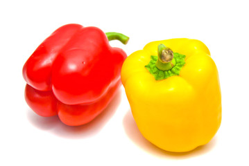Red and yellow peppers on white