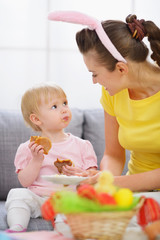 Mother with baby eating Easter cookies