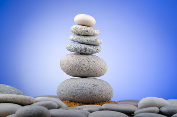 Balanced pebbles with colour background