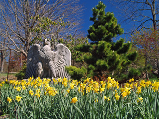 Bed of flowers with eagle statue