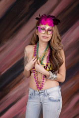 Hispanic woman with party mask and beads