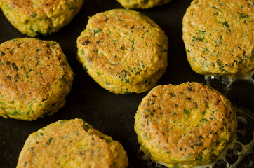 falafels being cooked on the griddle
