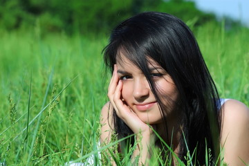 Girl with beautiful hair laying on the grass