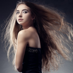 woman with flying hair looks back