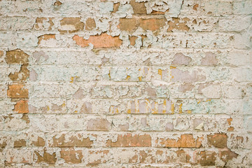 Old brick wall with peeling paint