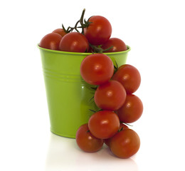 green basket with red tomatoes