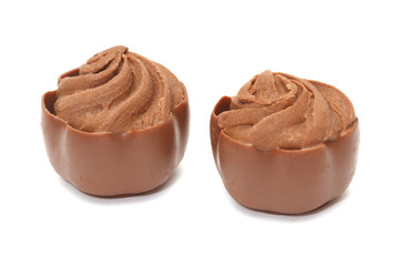 Chocolate pralines on white background