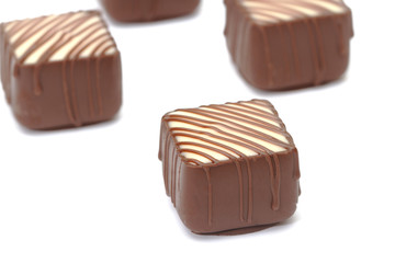 Chocolate pralines on white background