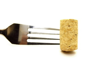 Fork and cork closeup on white background