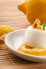 Vanilla Panna Cotta Dessert with lemon and fresh herbs