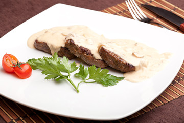 Roasted meat under white sauce