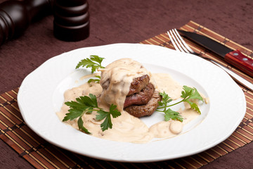 Roasted meat under white sauce