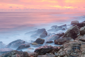 Fototapeta na wymiar Beautiful rocky sea beach at the sunset