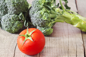 tomatoes and broccoli on wooden background