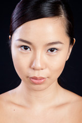 Fototapeta premium Pretty Asian woman with thoughtful look