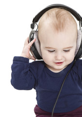 young child with ear-phones listening to music