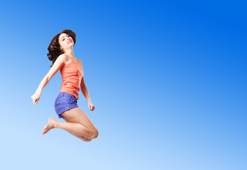 Fototapeta na wymiar jumping girl on background sky