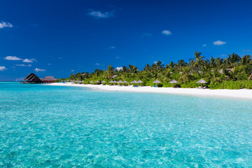 Tropical island with sandy beach and pristine water - obrazy, fototapety, plakaty
