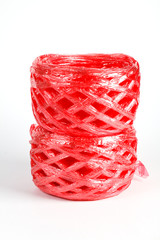 Roll red plastic ribbon on white background