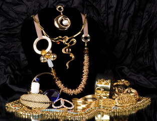 Golden jewelry on black background