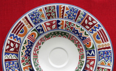 Three colorful plates in a red background
