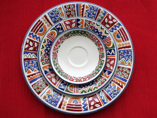 Three colorful plates in red background