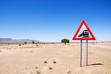 Warning of road sign - trains crossing the road, Namibia