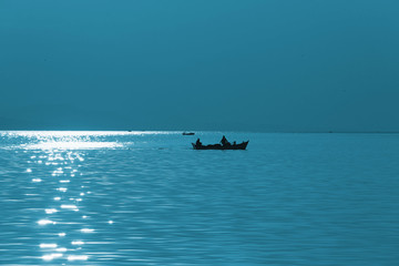 Fototapeta na wymiar Fishermen and blue sea