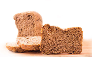 Sliced bread on kitchen board isolated on white background