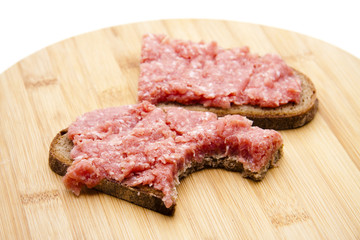 Mettwurstbrot auf Holzteller