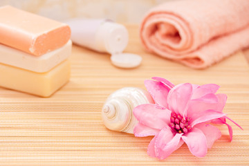 Obraz na płótnie Canvas daily spa objects, towel, soaps, lotion, flower