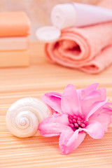Obraz na płótnie Canvas daily spa objects, towel, soaps, lotion, flower