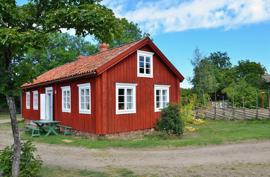 typical scandinavian red wooden house in village