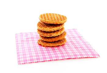 Pile of typical Dutch stroopwafels ( with syrup) on napkin