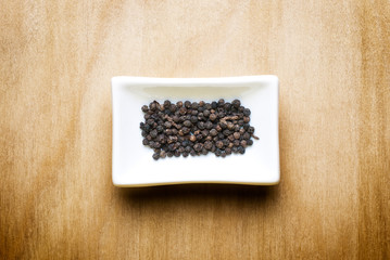 black pepper on wood table