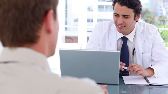 Black-haired doctor talking with his patient