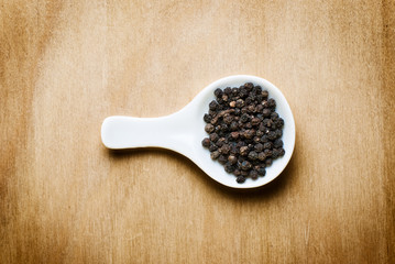 black pepper on wood table